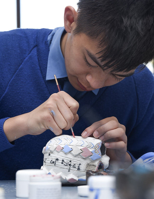 Patrician Brothers Catholic College Blacktown student painting clay sculpture