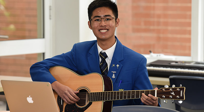 Patrician Brothers Catholic College Blacktown student playing guitar