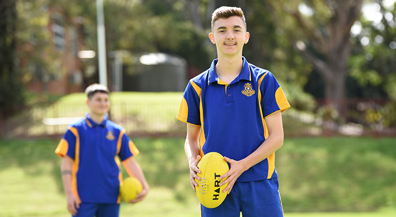Patrician Brothers Catholic College Blacktown students holding a football