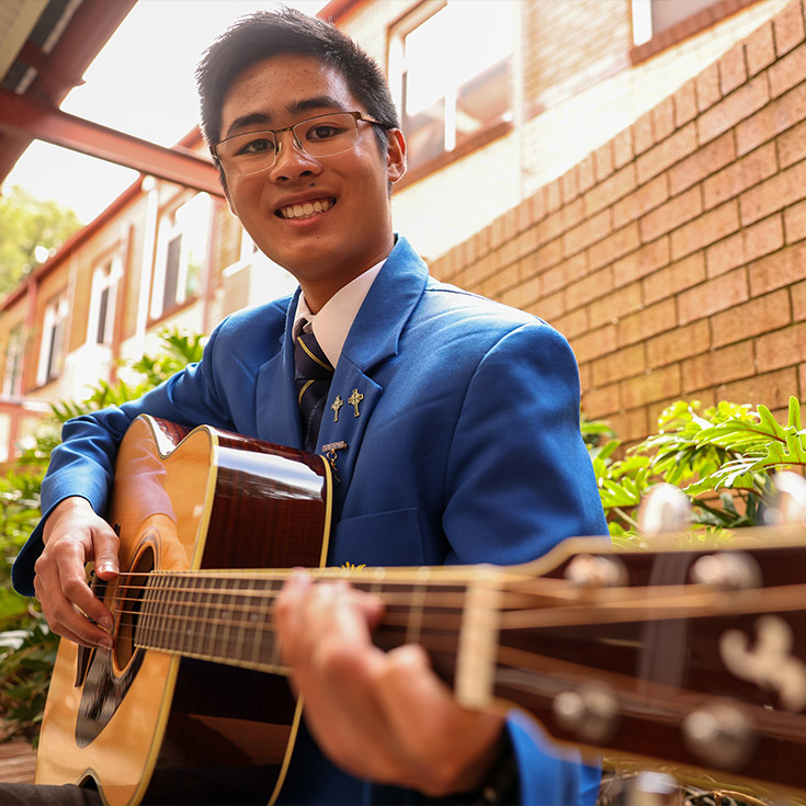 Patrician Brothers Catholic College Blacktown student playing guitar
