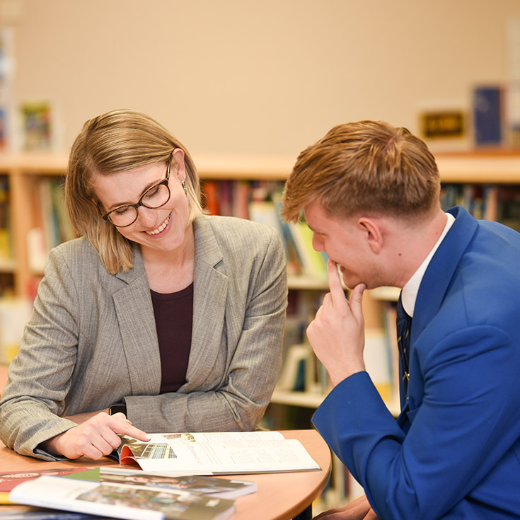 Teacher helping student at Patrician Brothers Blacktown