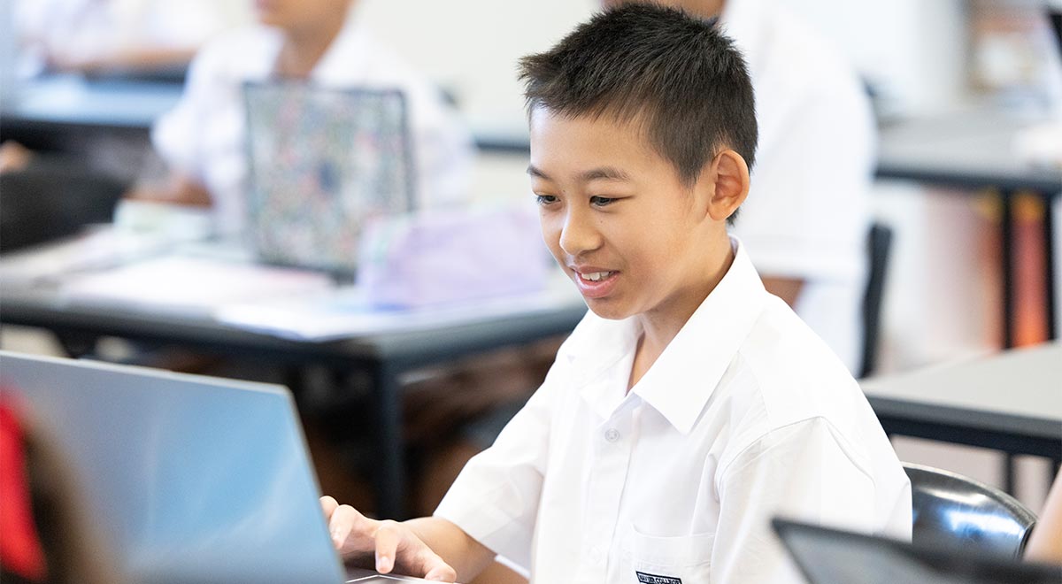 Student, from Xavier Catholic College Llandilo, working from laptop in class